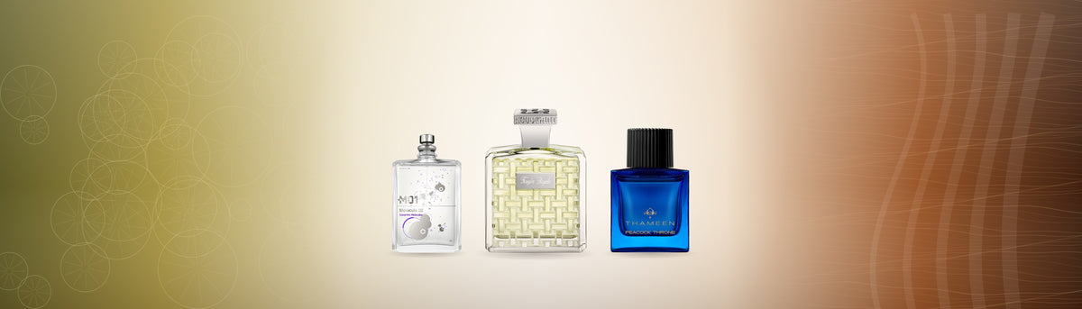 Die Flakons Molecule 01, Fougère Royale Extrait und Peacock Throne vor einem Verlauf von zitrisch-goldenem zu holzig-kupfernem Licht