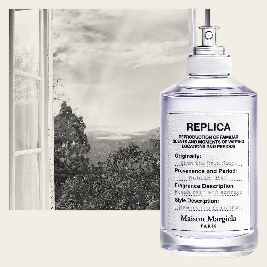 Replica When the Rain Stops by Maison Margiela – bottle by a window with rainbow (mood shot)