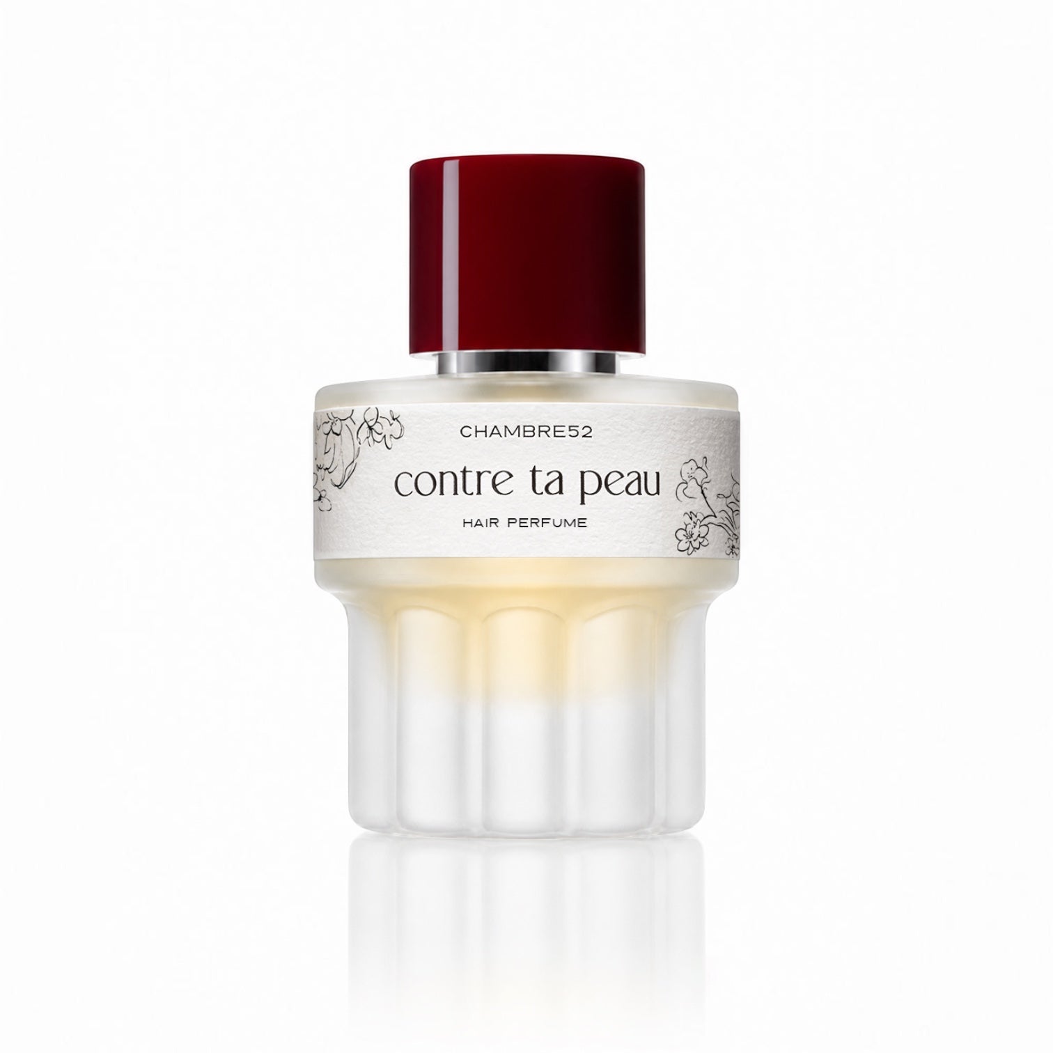 CHAMBRE52 Contre ta Peau Hair Perfume im weißen Flakon mit skulpturalem Sockel, roter Verschlusskappe und dekorativem Etikett.